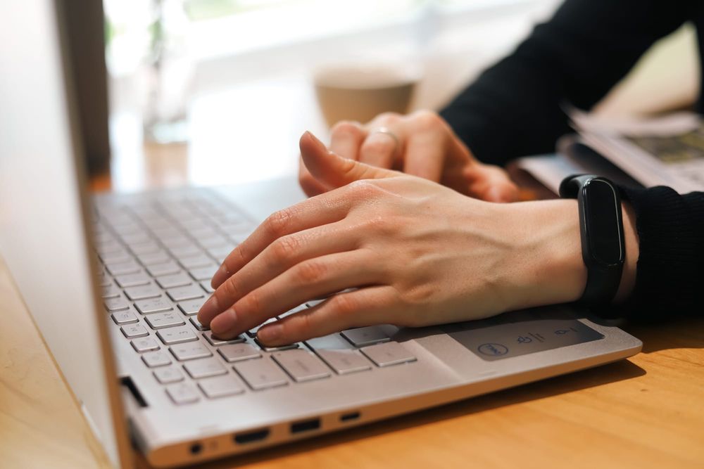 Hands typing on laptop keyboard post image