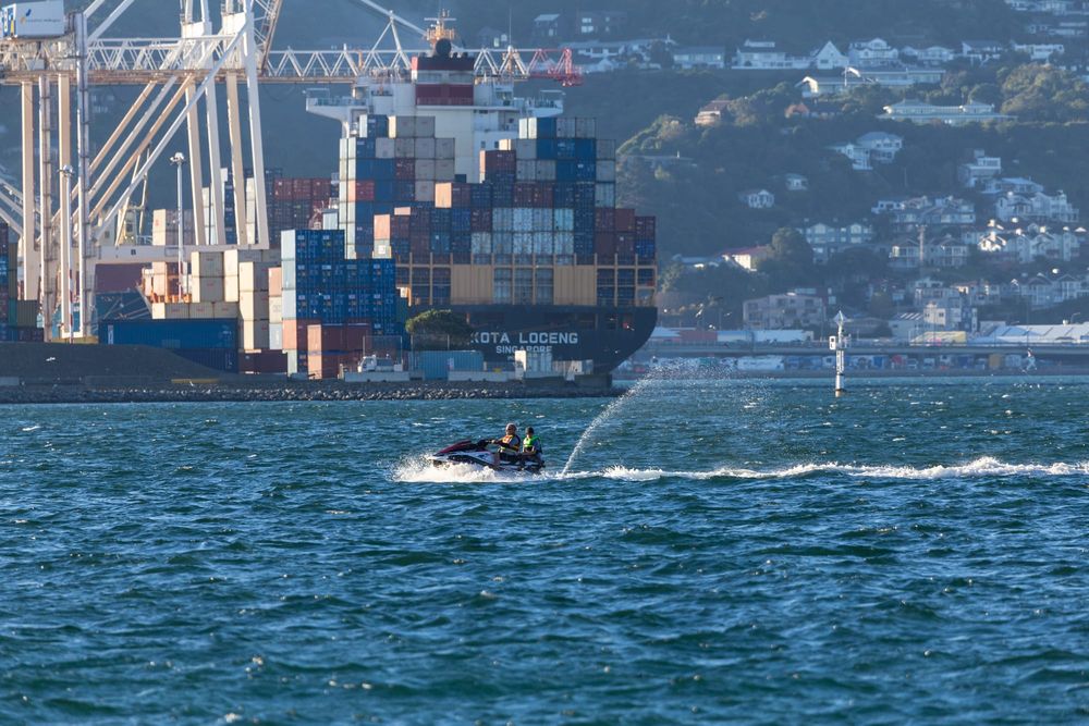 Jet ski and cargo ship in harbour post image