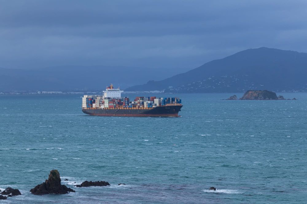 Ship viewed from rocky shoreline post image