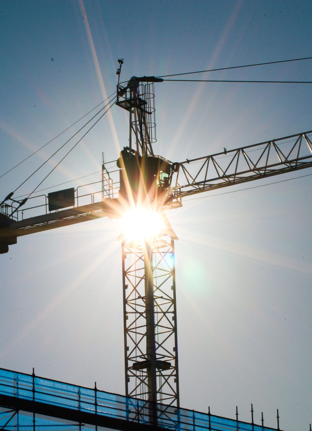 Sunburst through crane structure post feature image