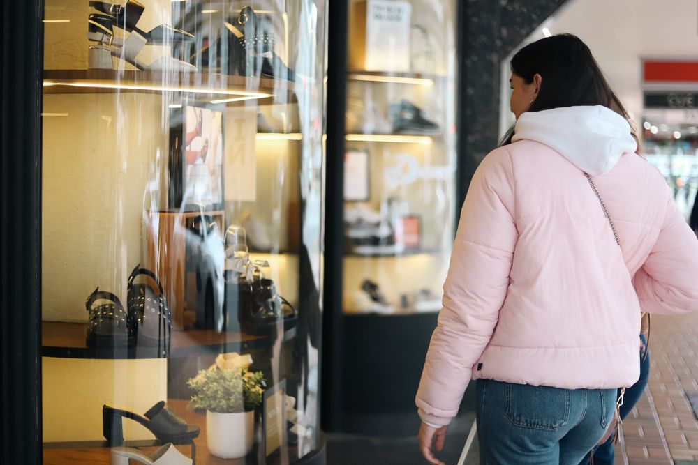 Woman browsing shoe store display post image