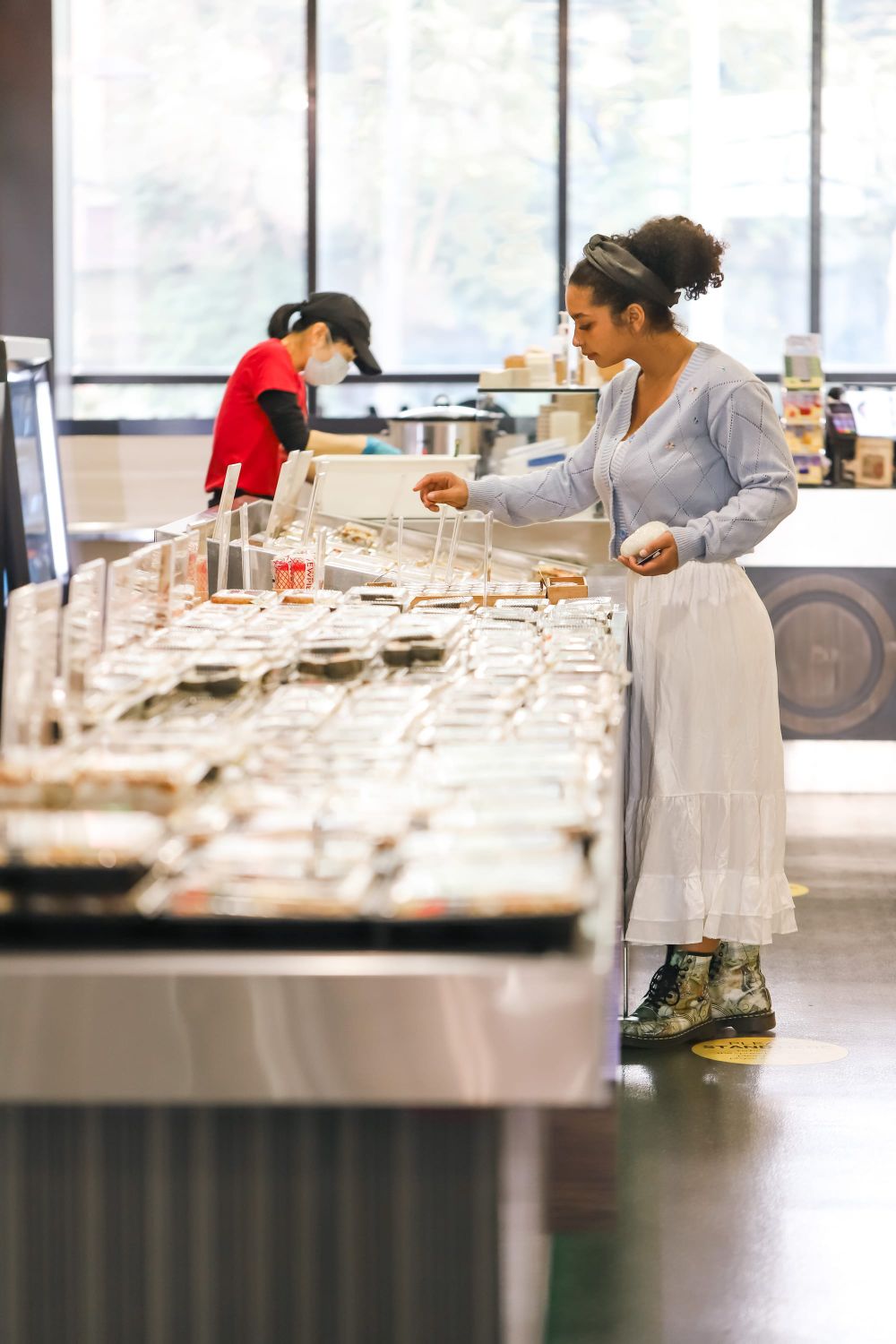 Woman selecting food at a self-service counter post image