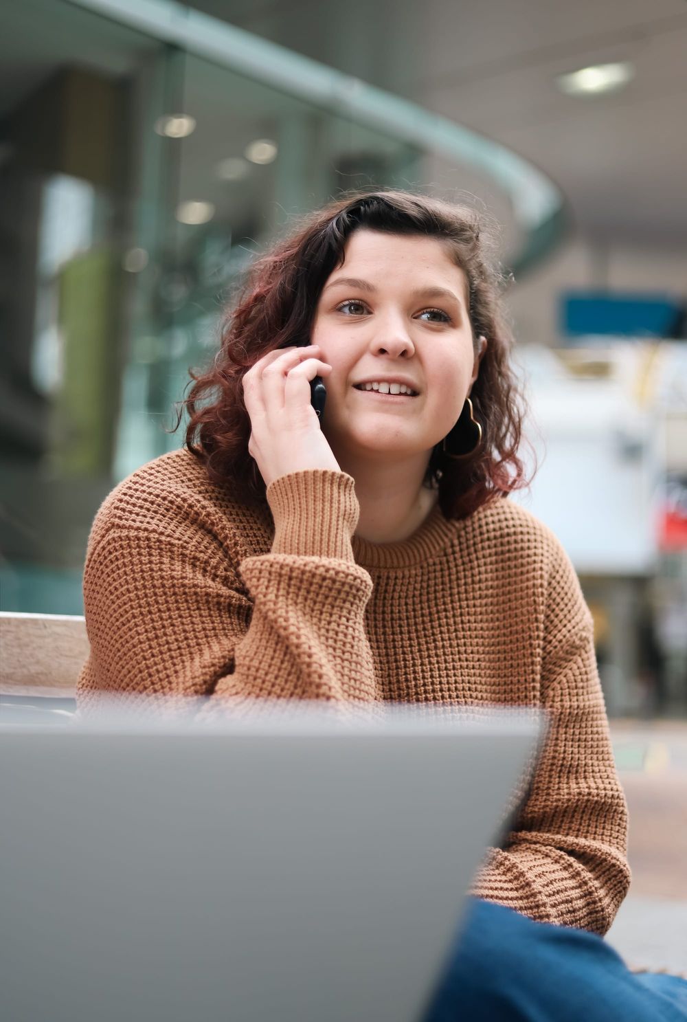 Woman talking on phone outdoors post image