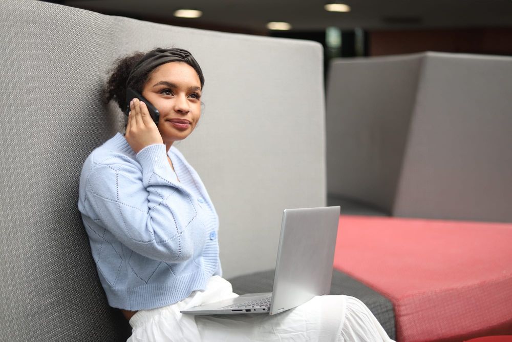 Woman relaxing on sofa with laptop post image