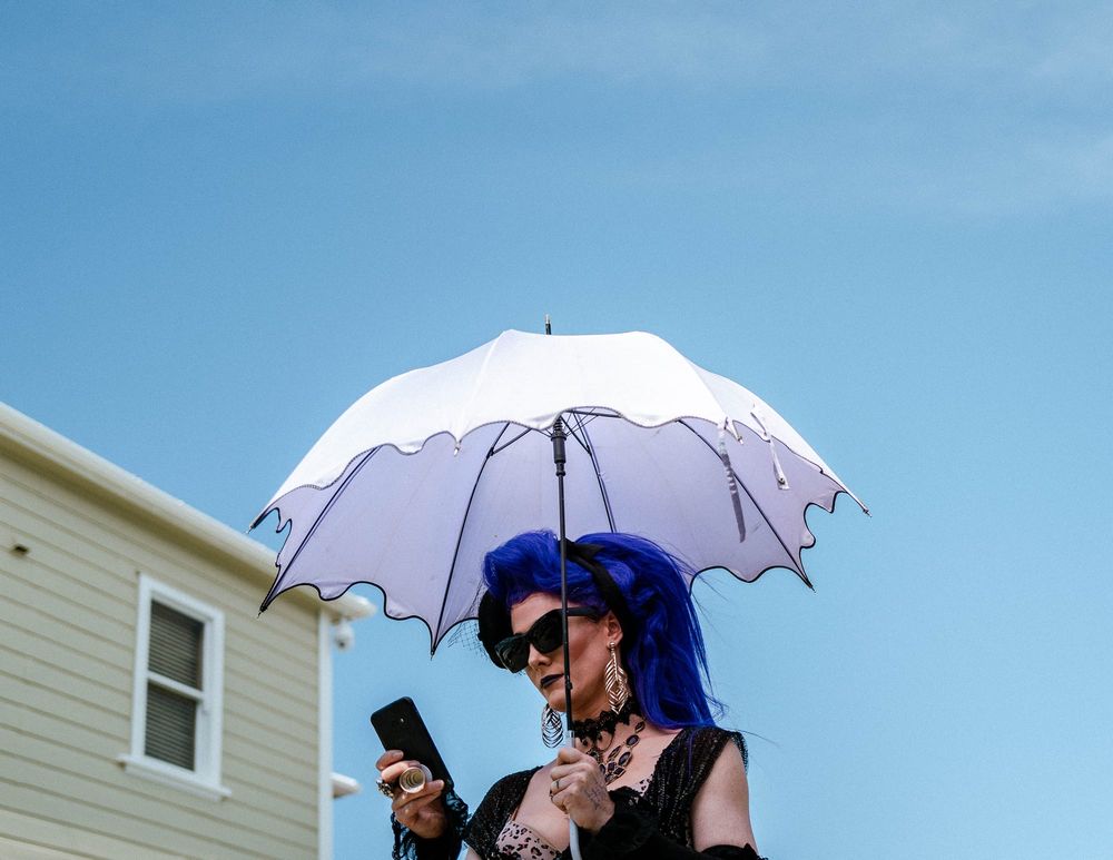 Woman with an umbrella and    blue hair post feature image