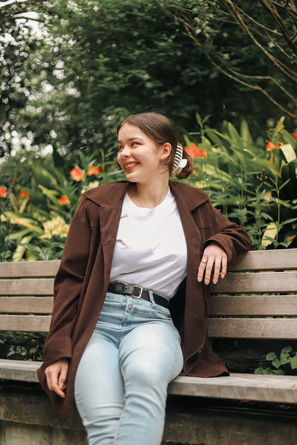 Girl sits on a wooden bench post image