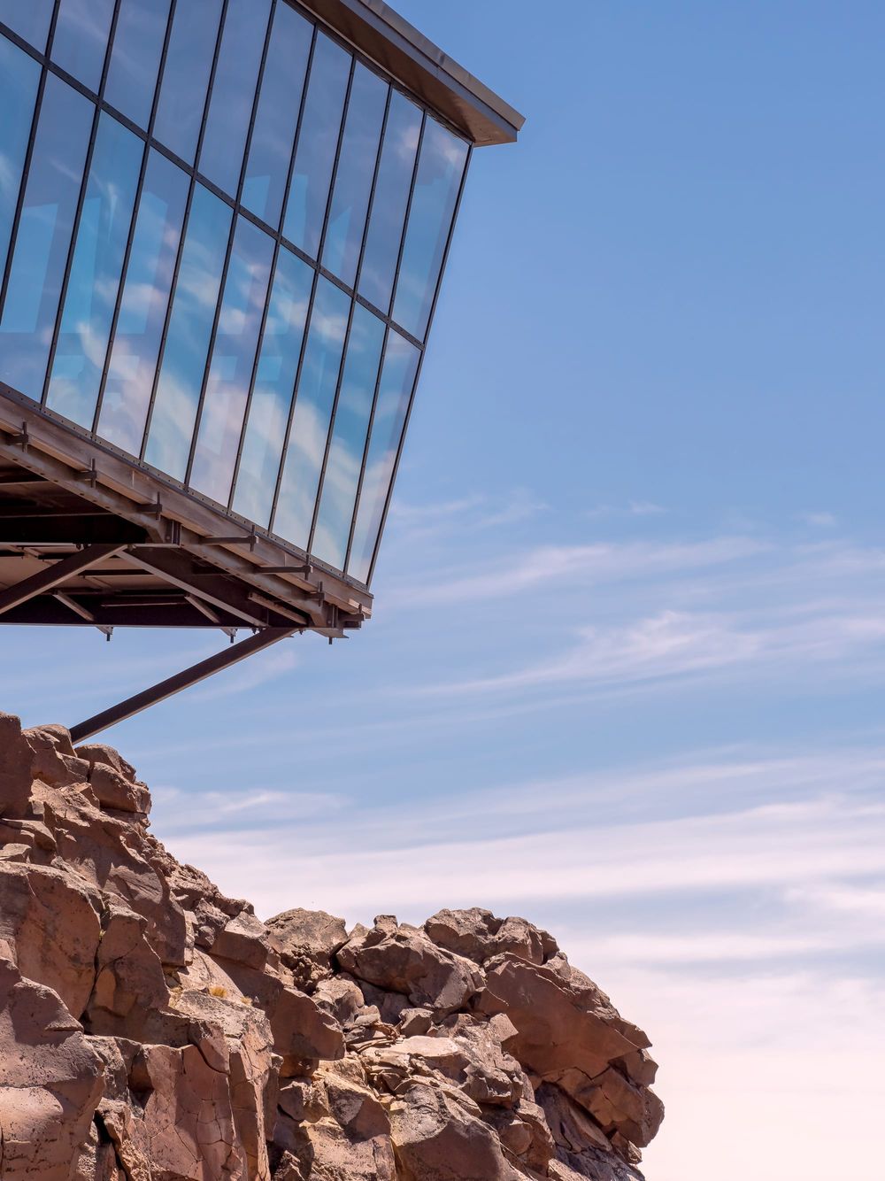 Glass building rocks mountain post image