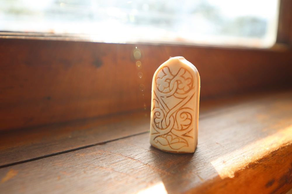 Lewis chess pawn on a wooden surface post image