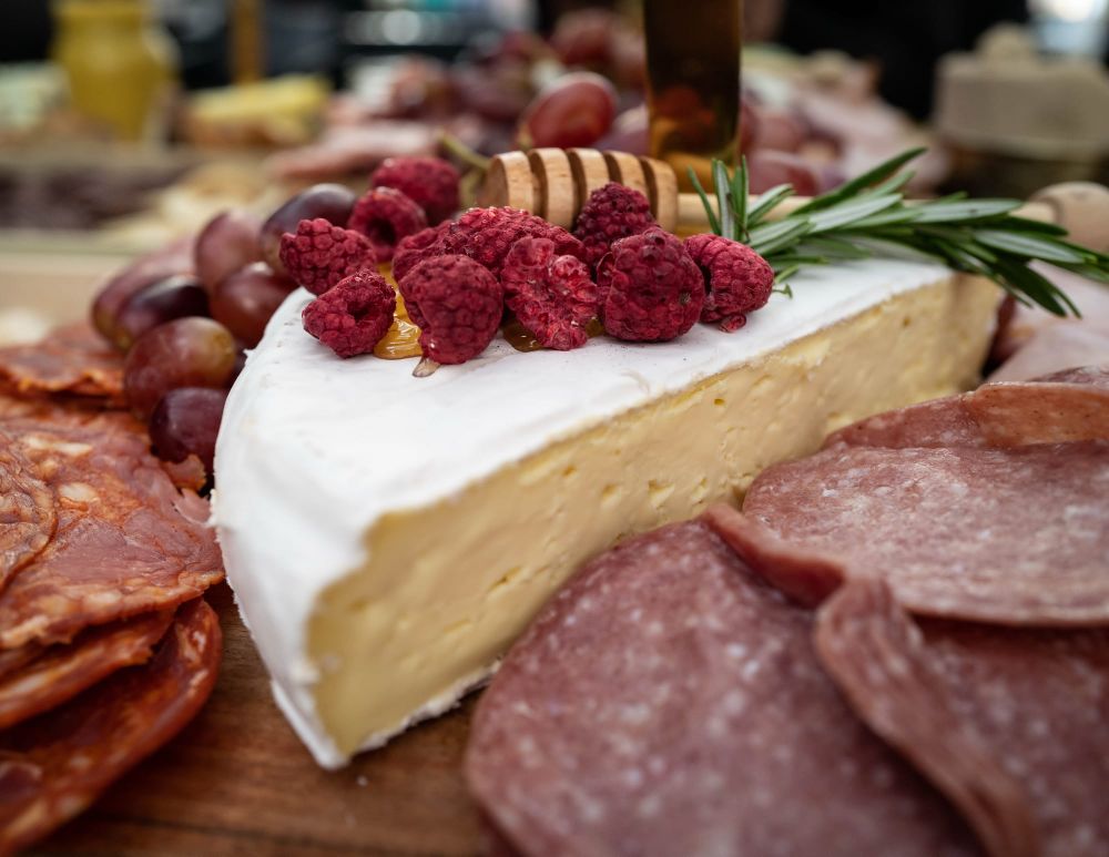 Cheese and cured meats with honey and raspberries post image