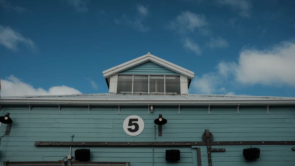 Light blue building with number 5 post image