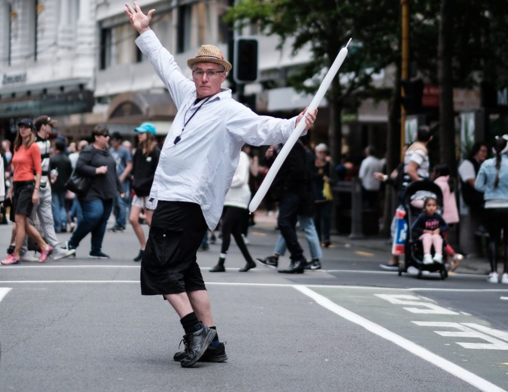 Street performer posing with a balloon post image