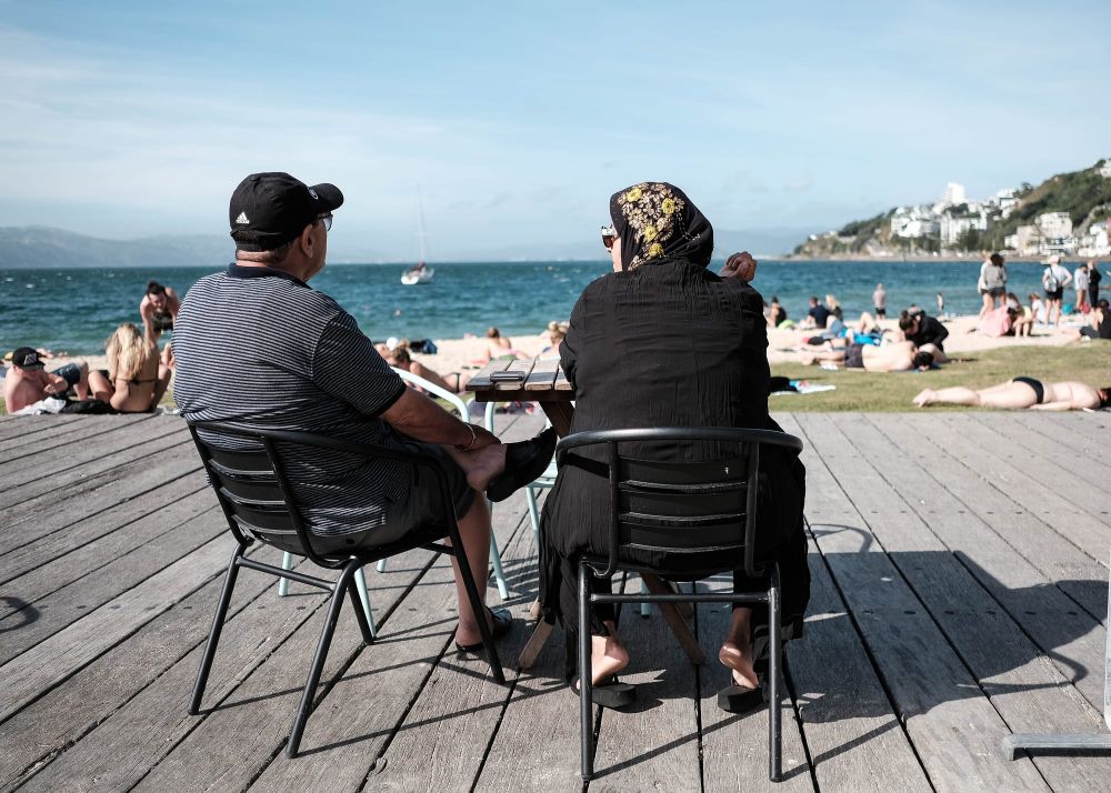 Two seated figures on a sunny deck post image