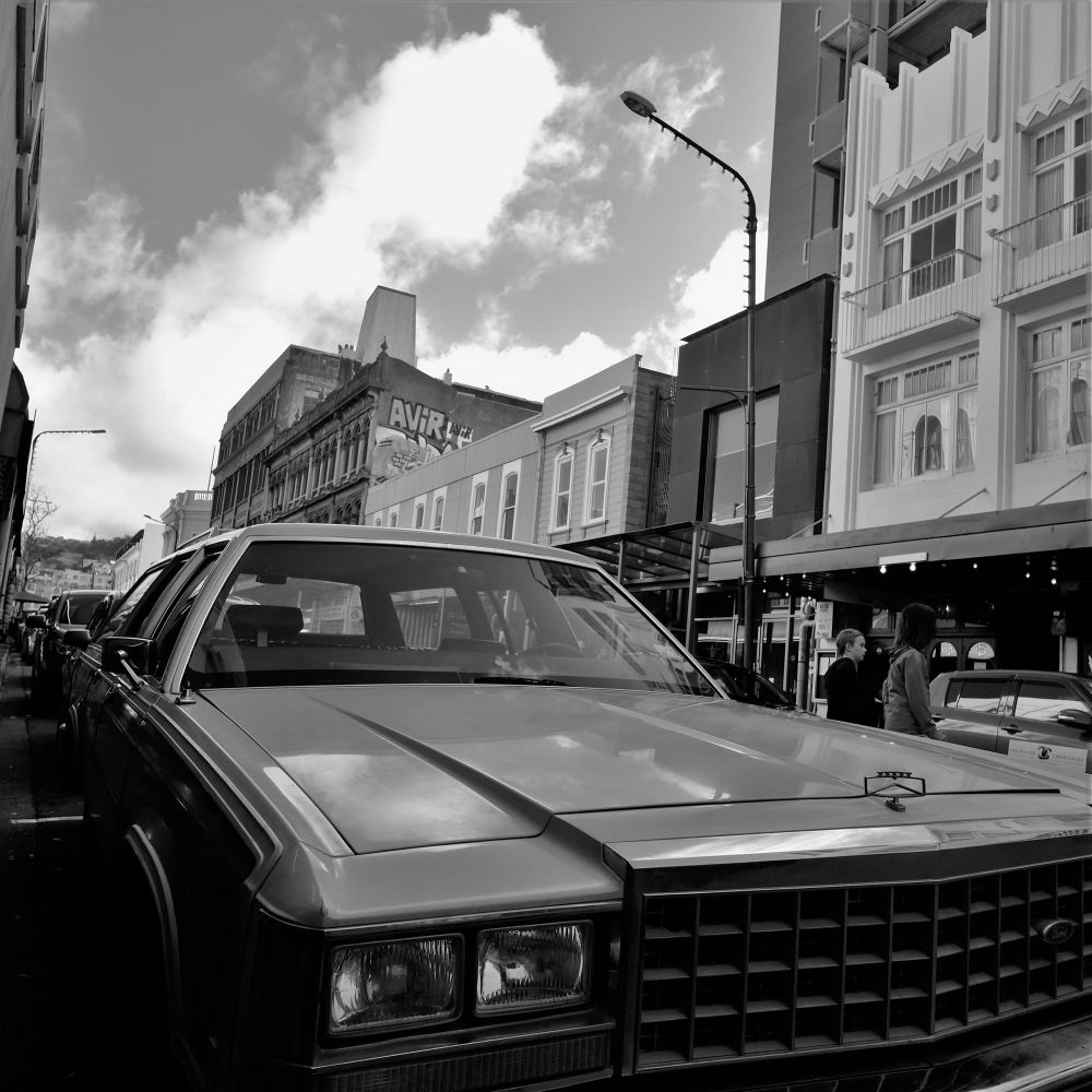 Vintage car parked on a city street post image