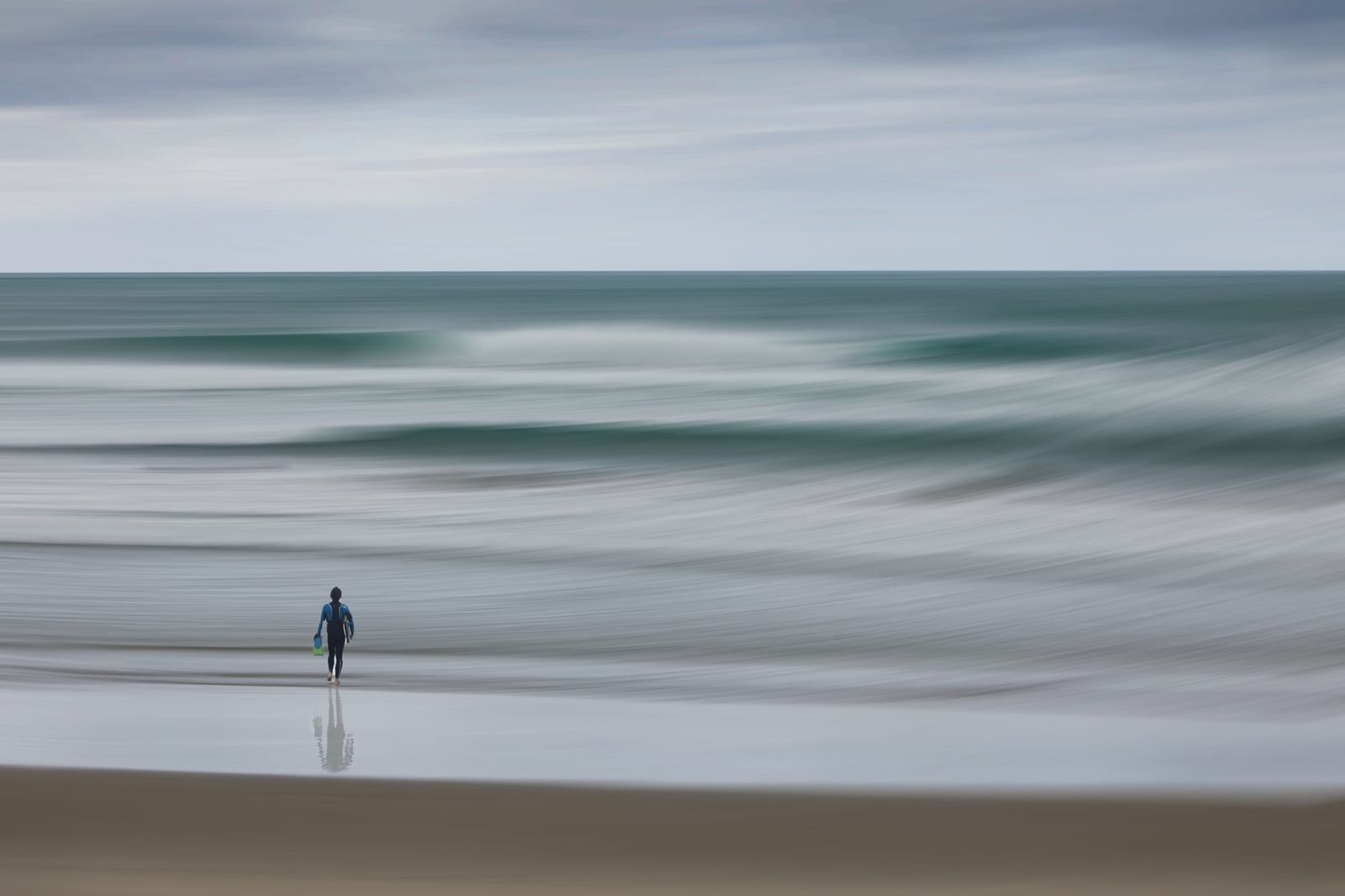 Surfer and a stormy Whangamata