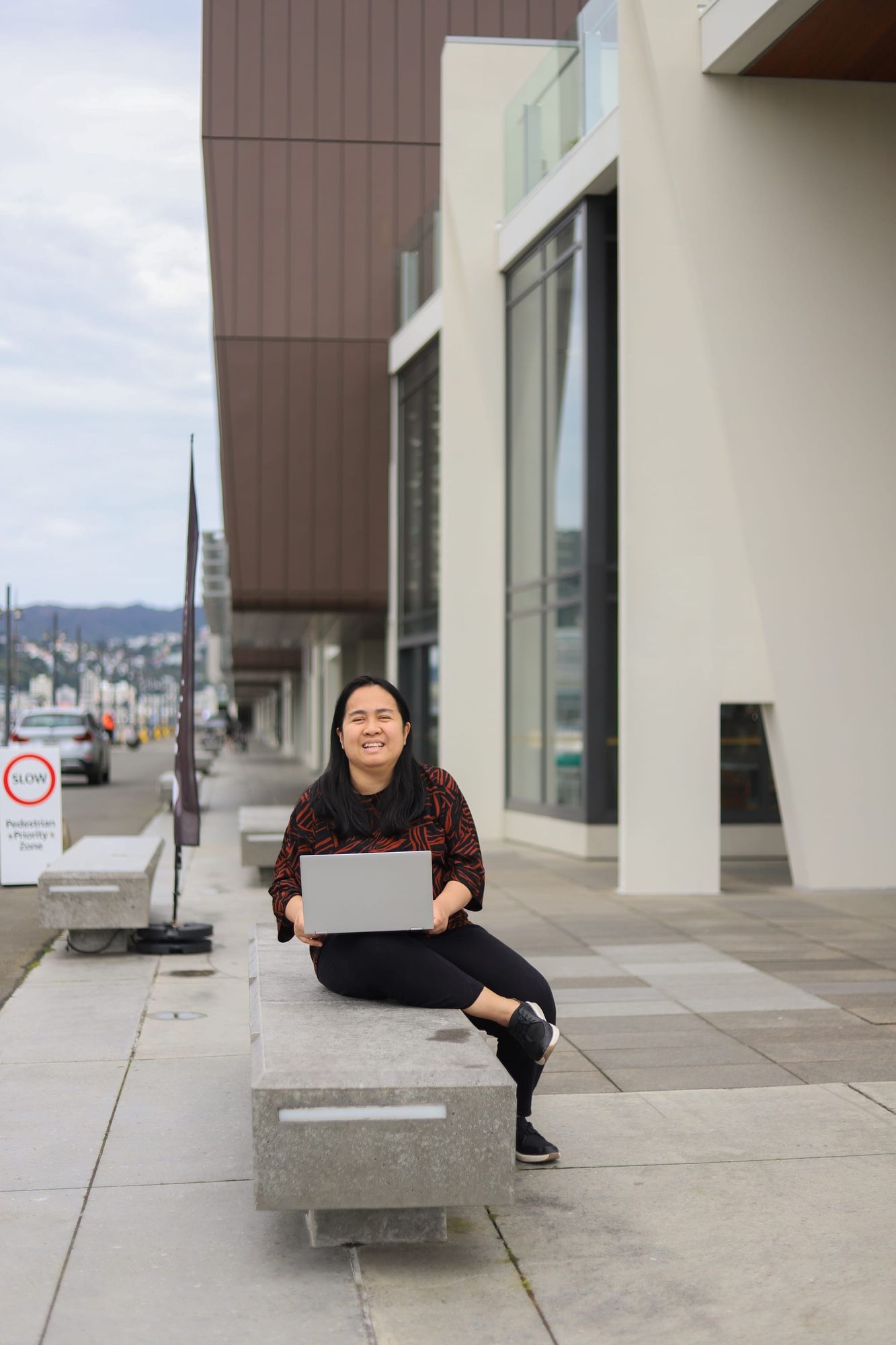 Smiling and working outdoors on the waterfront