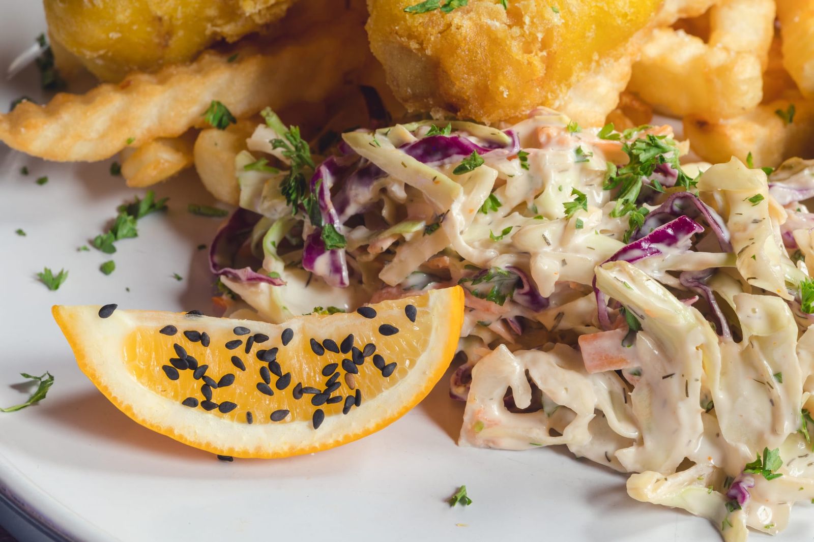 Sesame seeds on citrus fruit and coleslaw