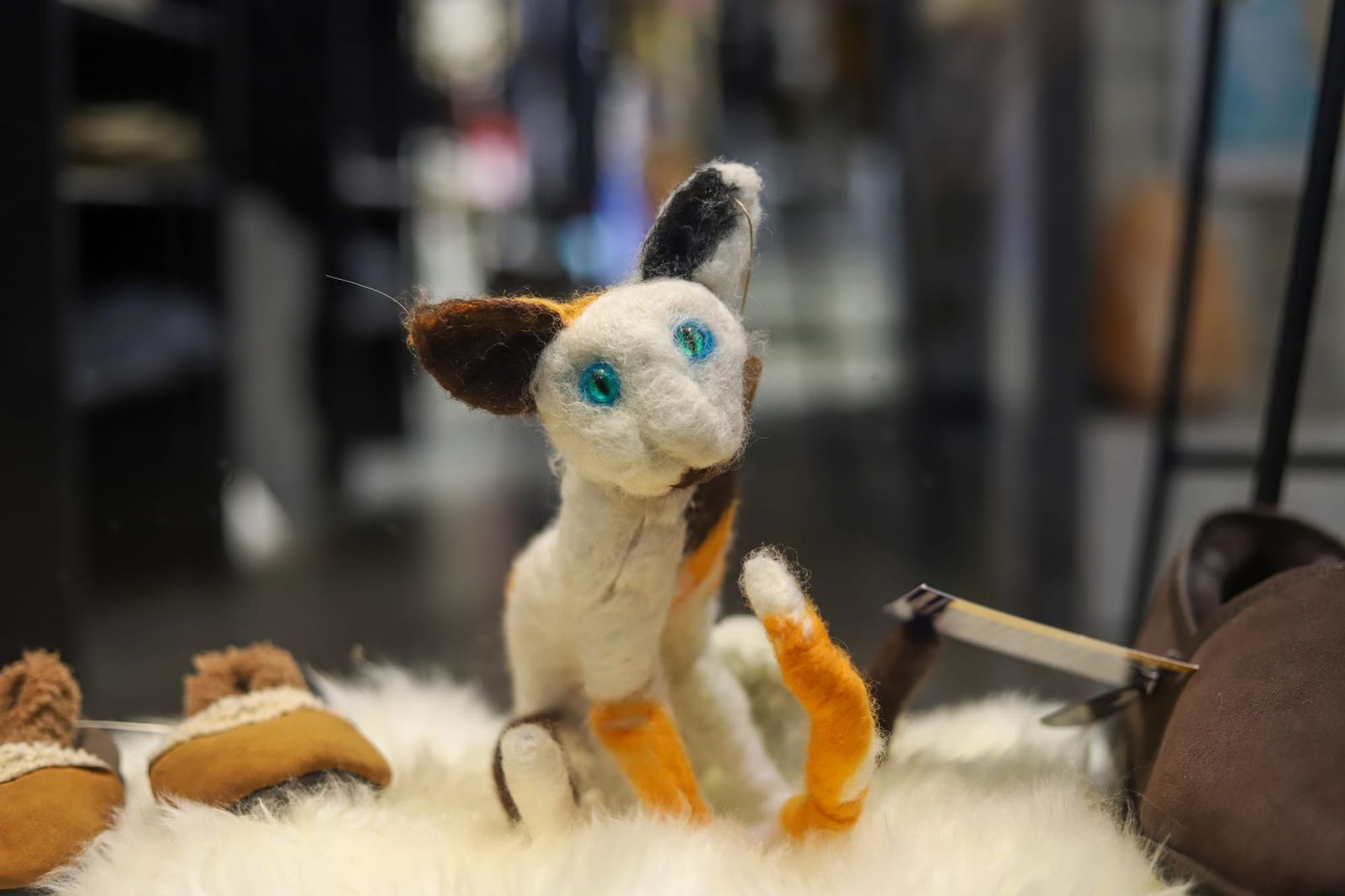 Felted toy cat with blue eyes