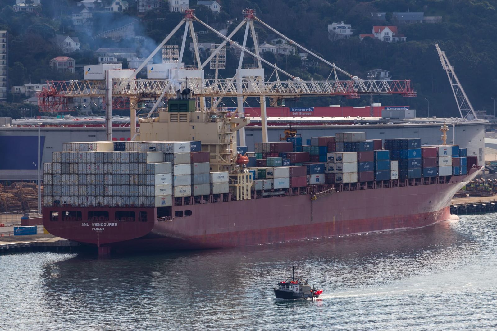 Red cargo ship in harbour