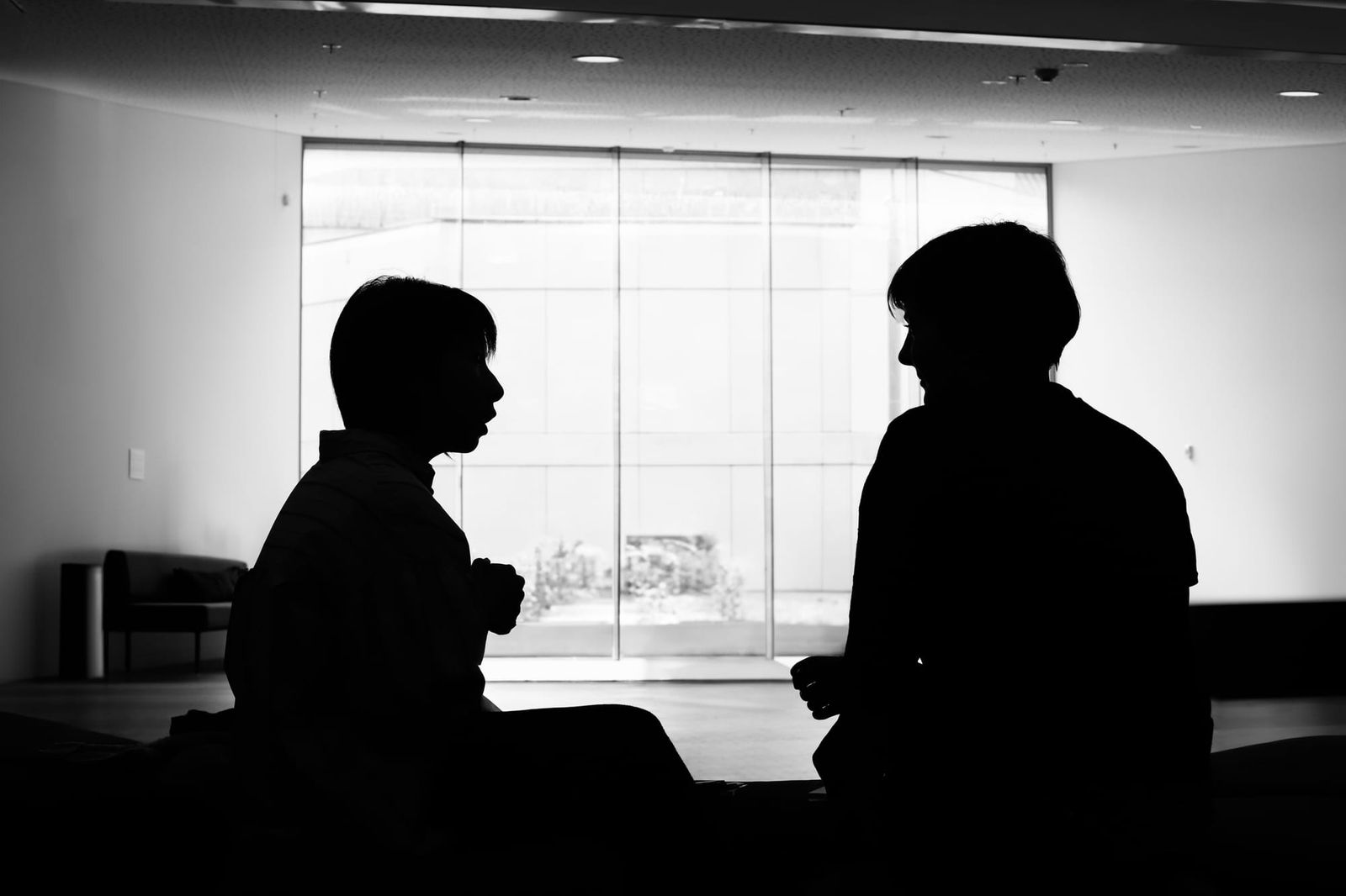 Silhouette of two people in conversation