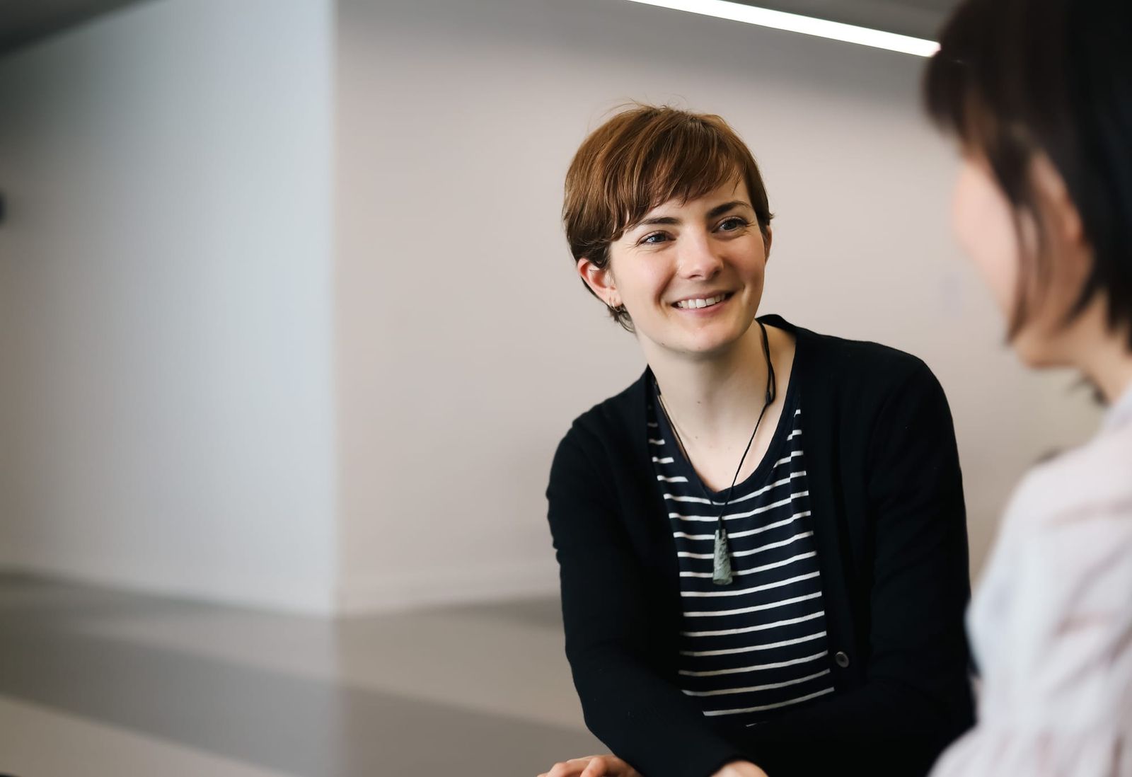 Professional woman smiling during a discussion