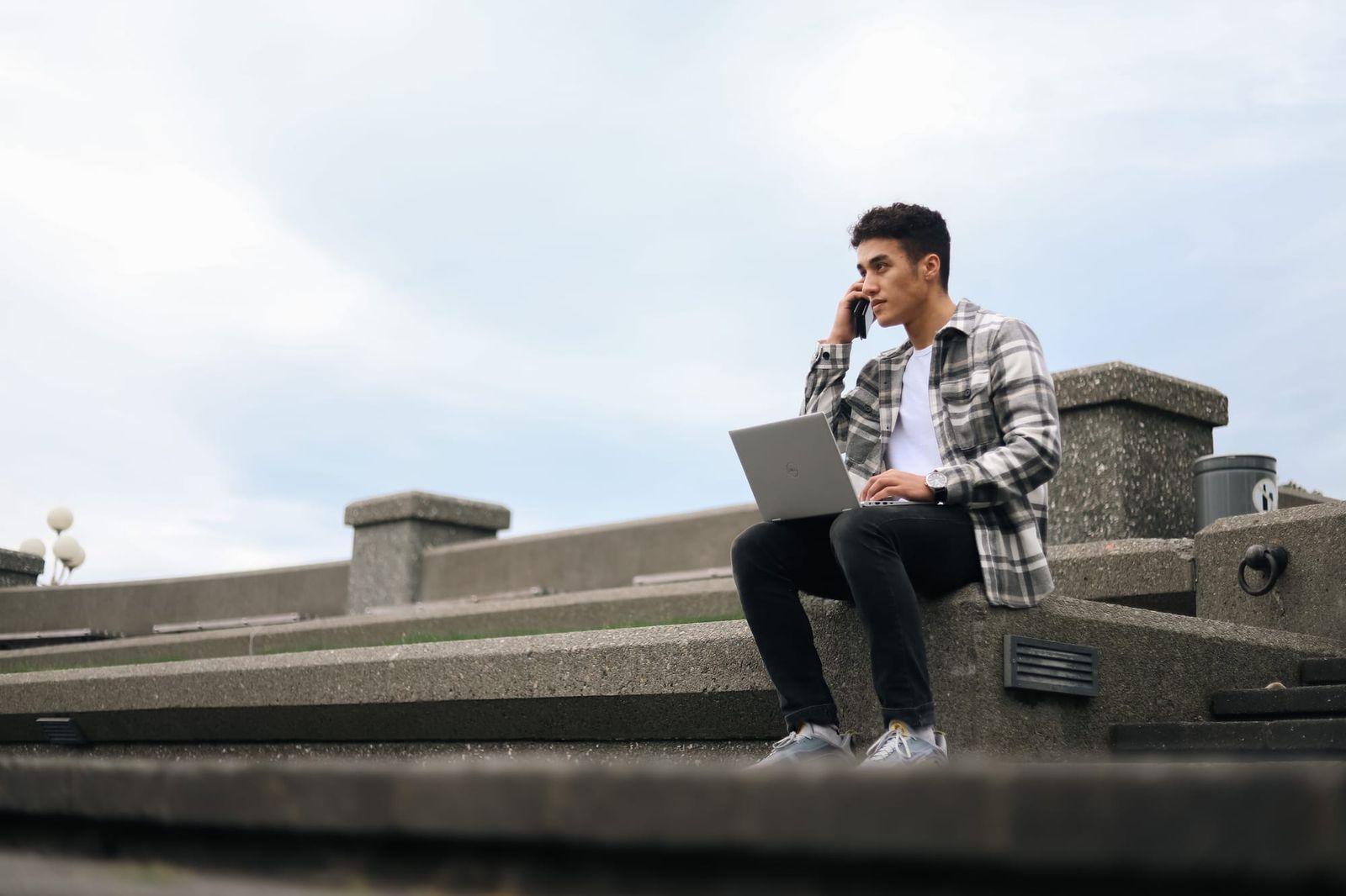 Student on phone with laptop