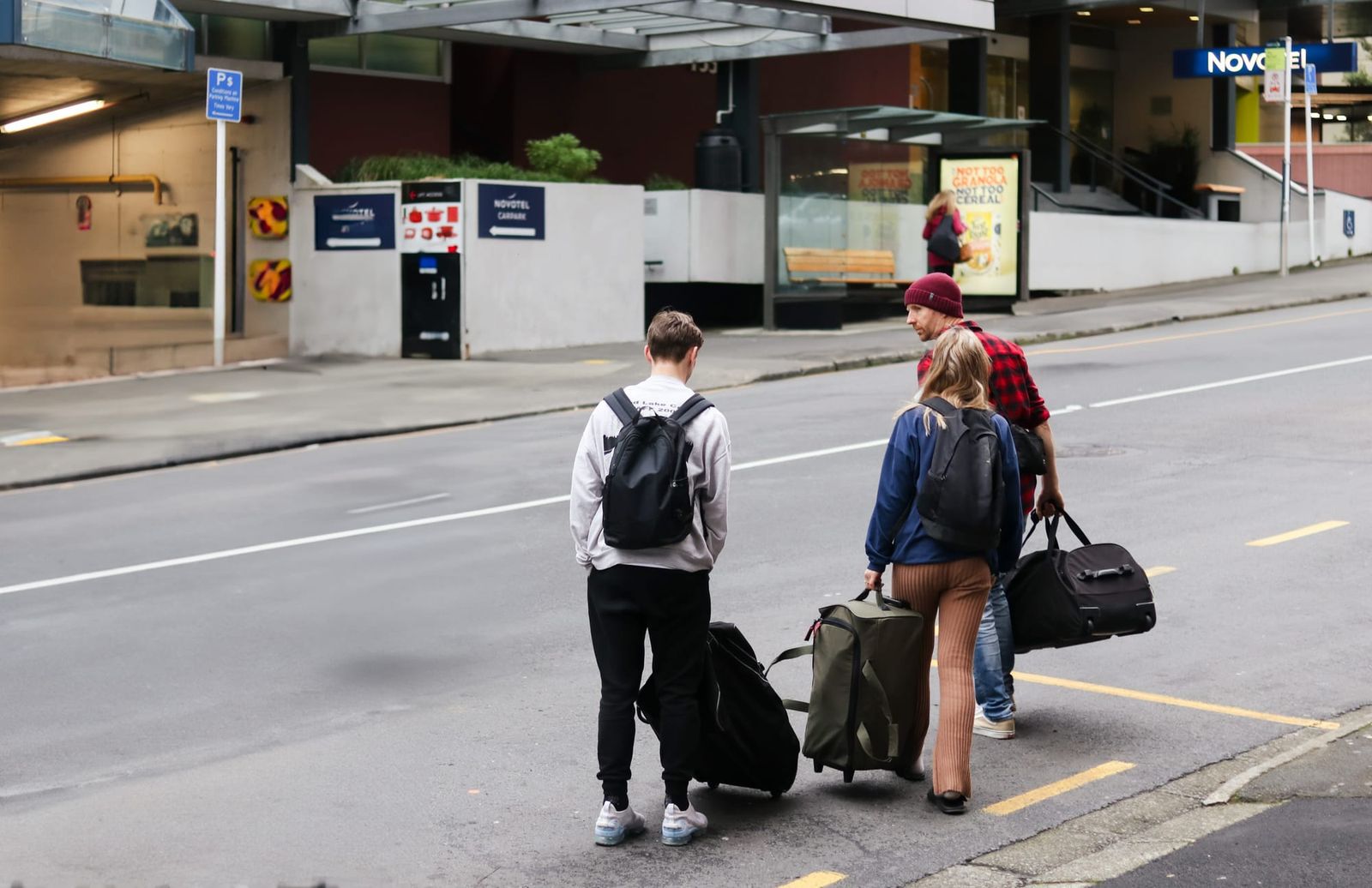 Travelers with luggage in city street