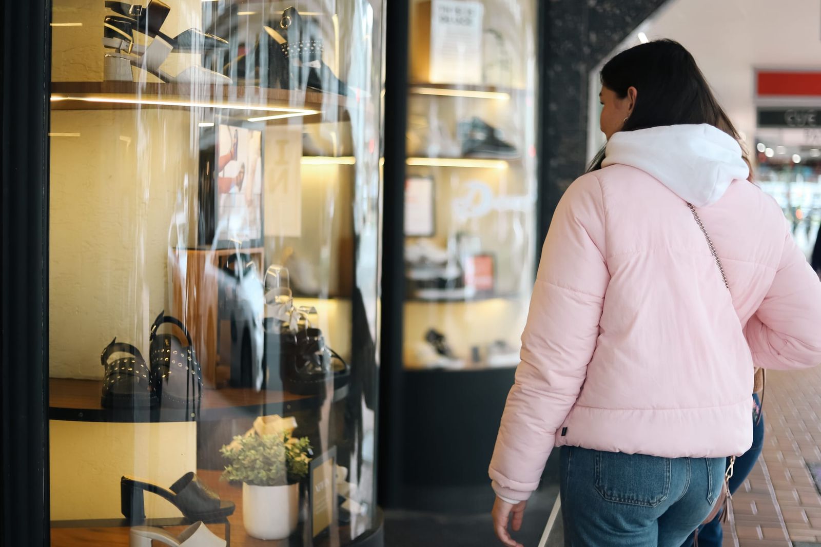 Woman browsing shoe store display