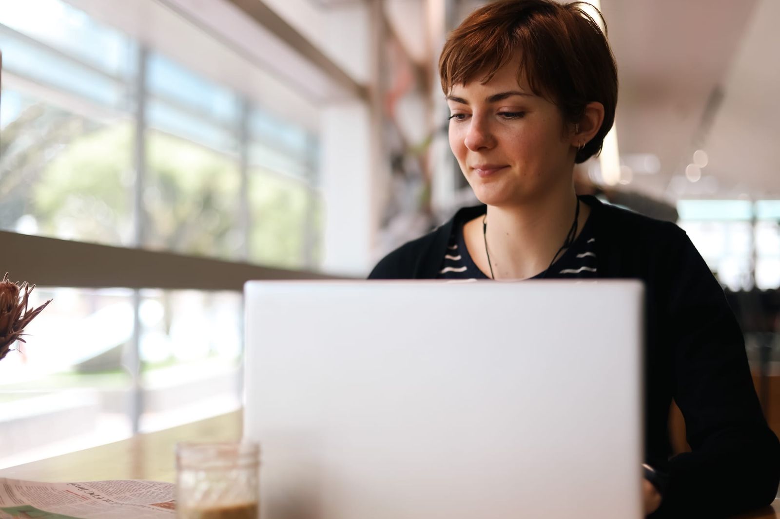 Woman with laptop in cafe