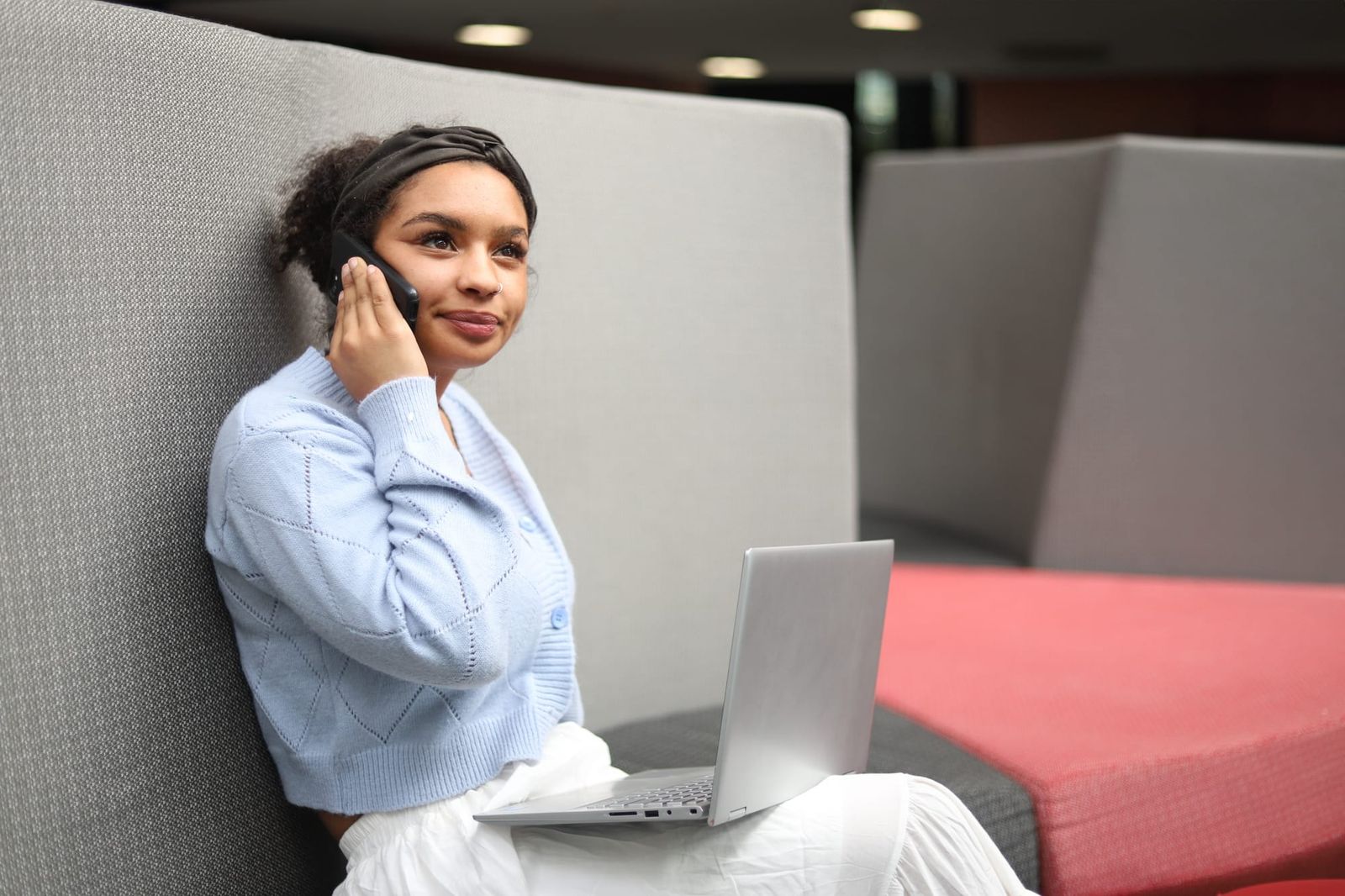 Woman relaxing on sofa with laptop