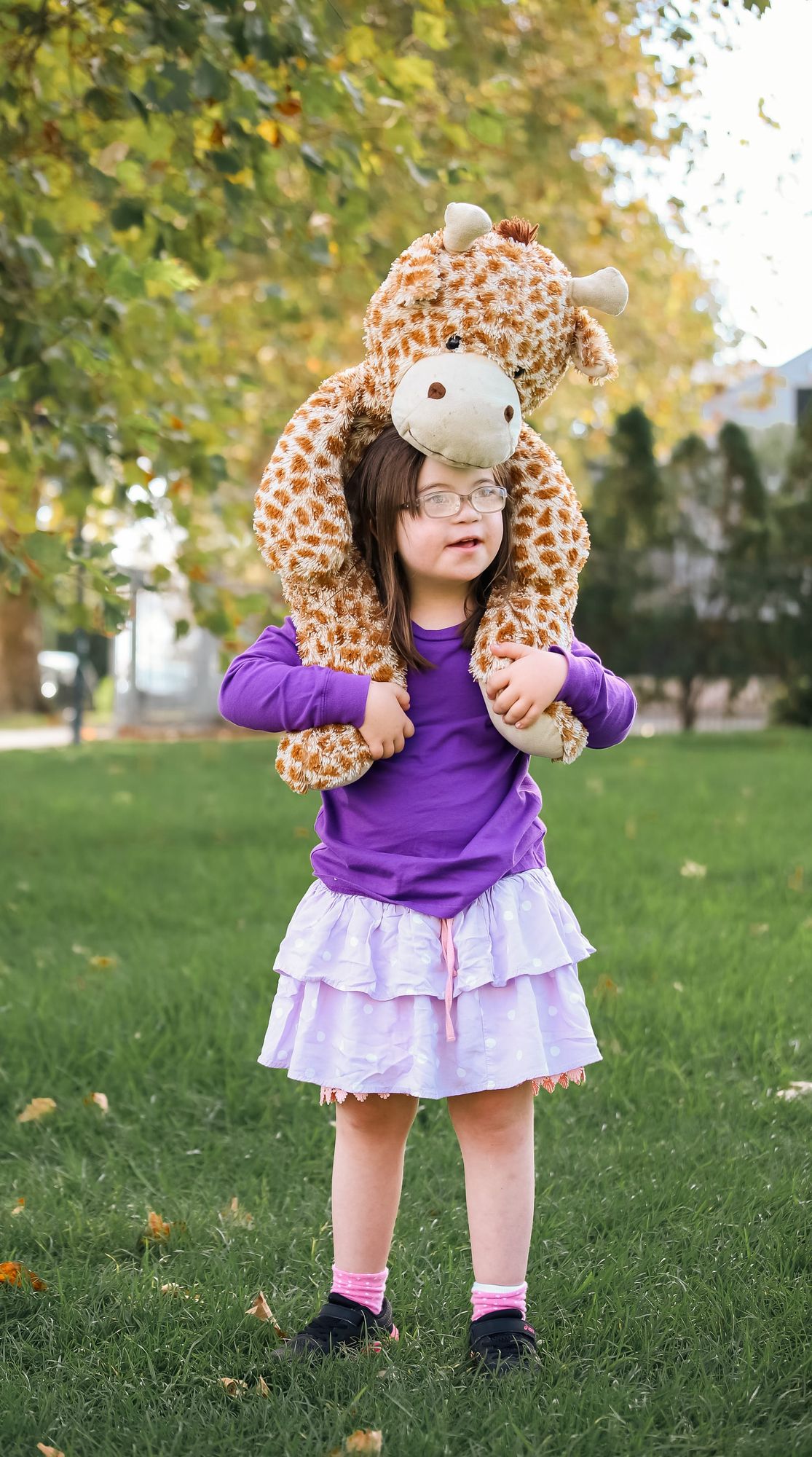 Child with a plush giraffe