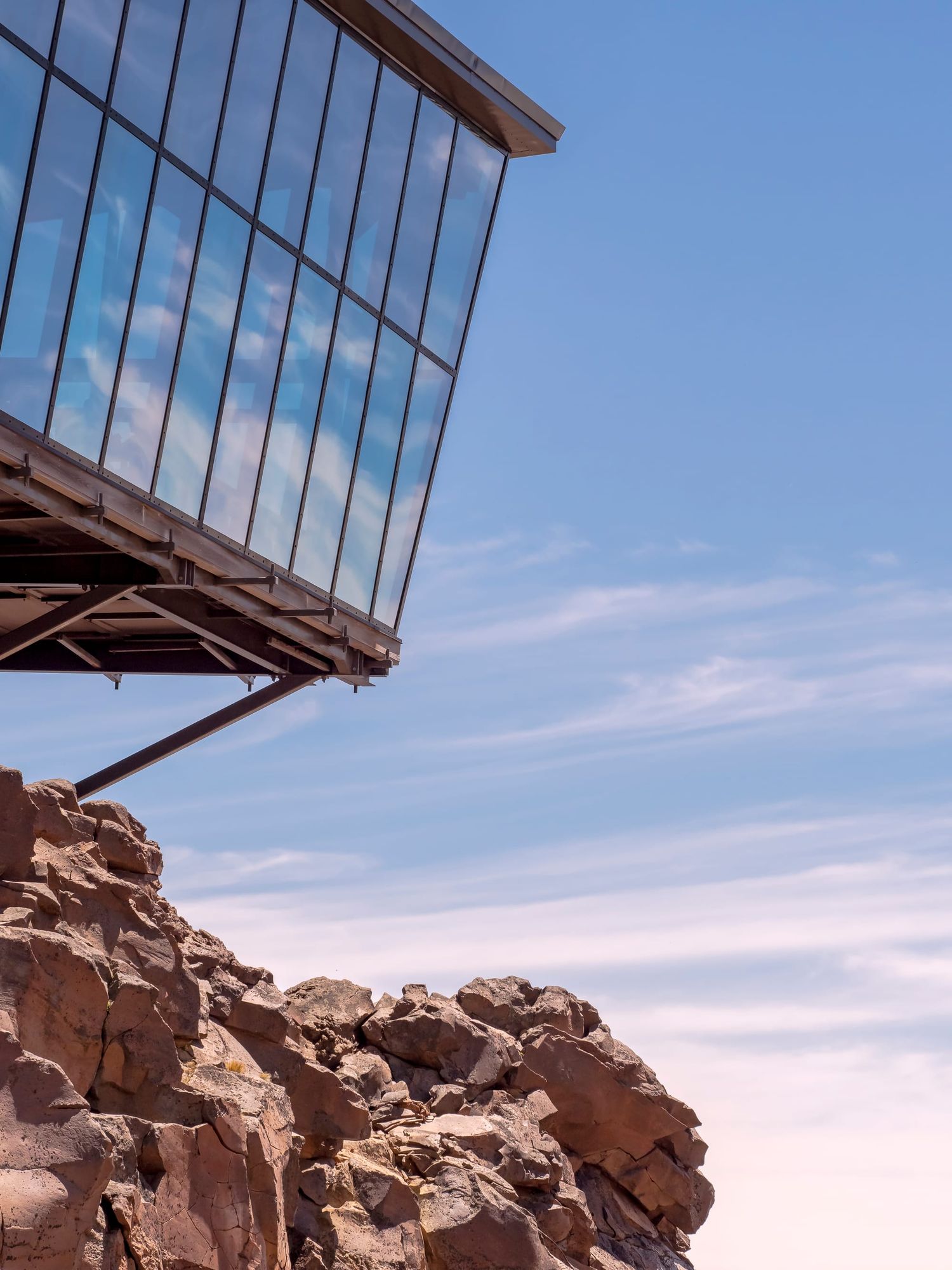Glass building rocks mountain