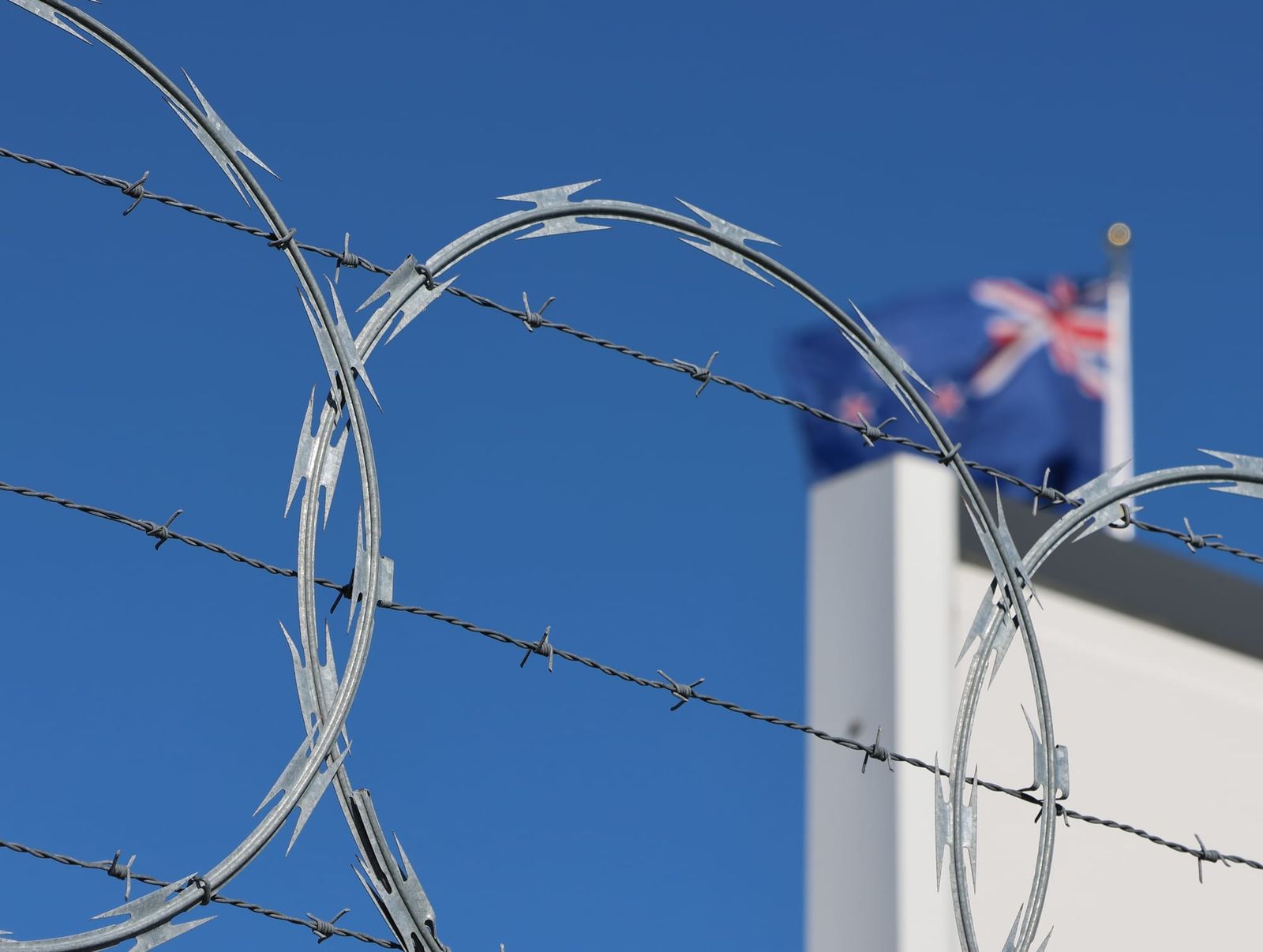 Razor wire and flag