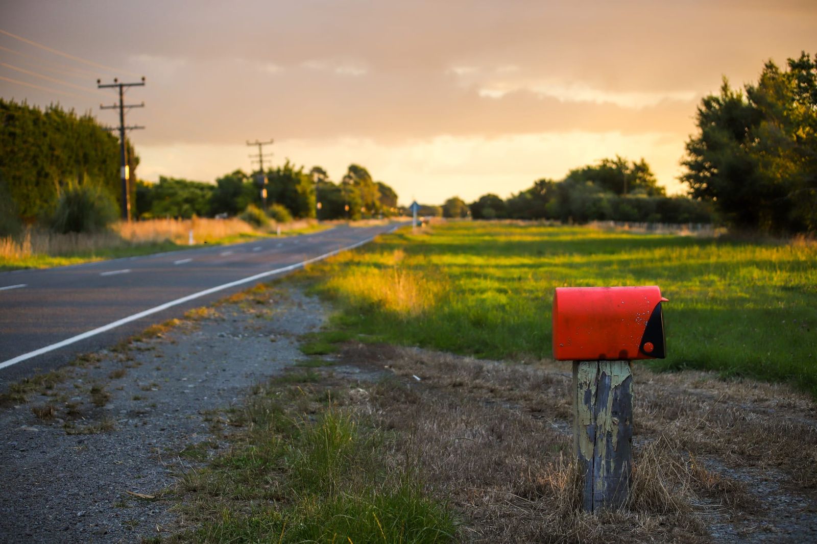 Red mailbox and countryside road