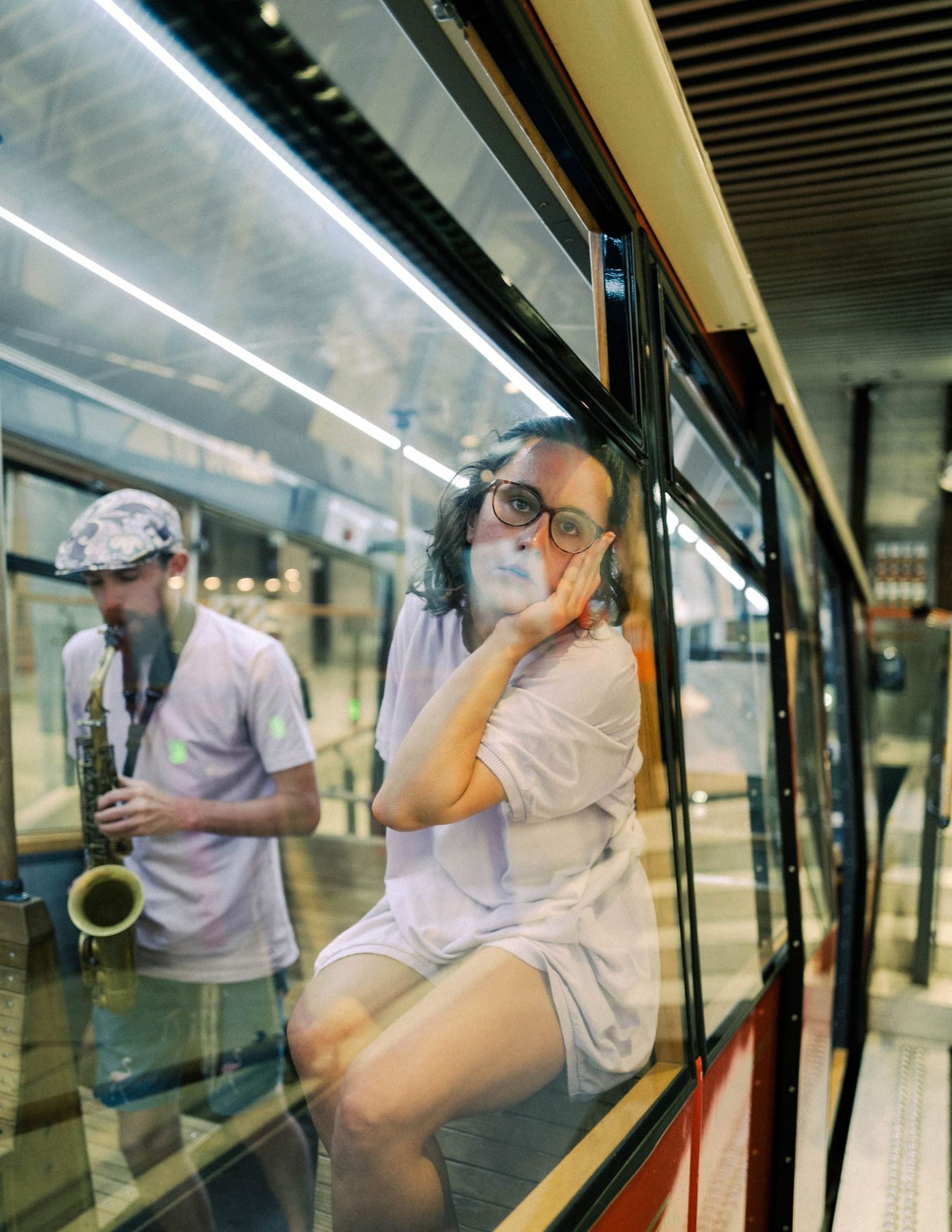 Reflection and saxophone at tram station