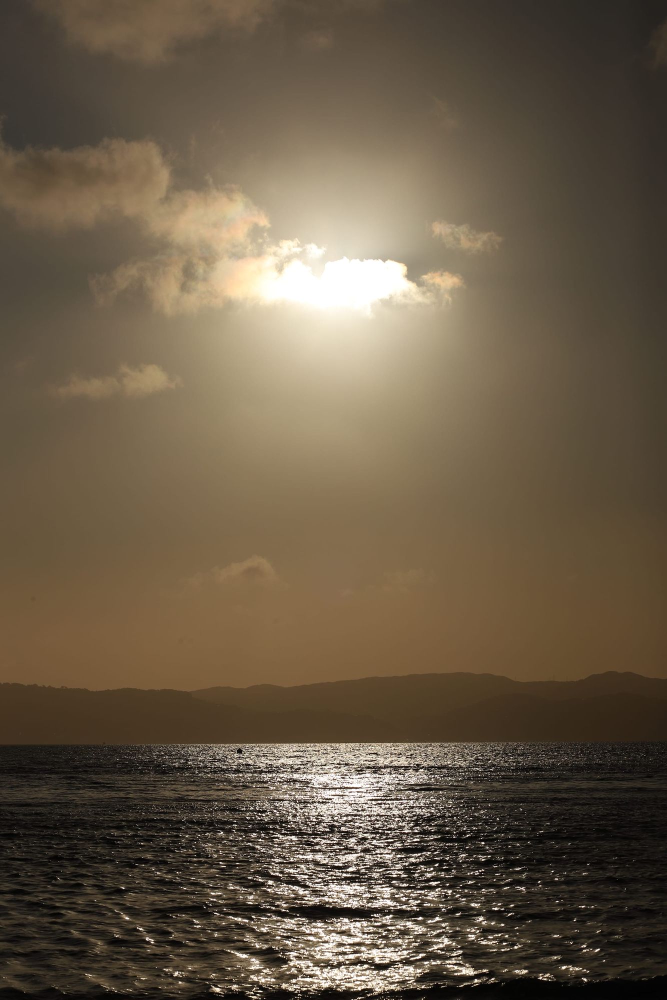 Seascape glow and cloud veil
