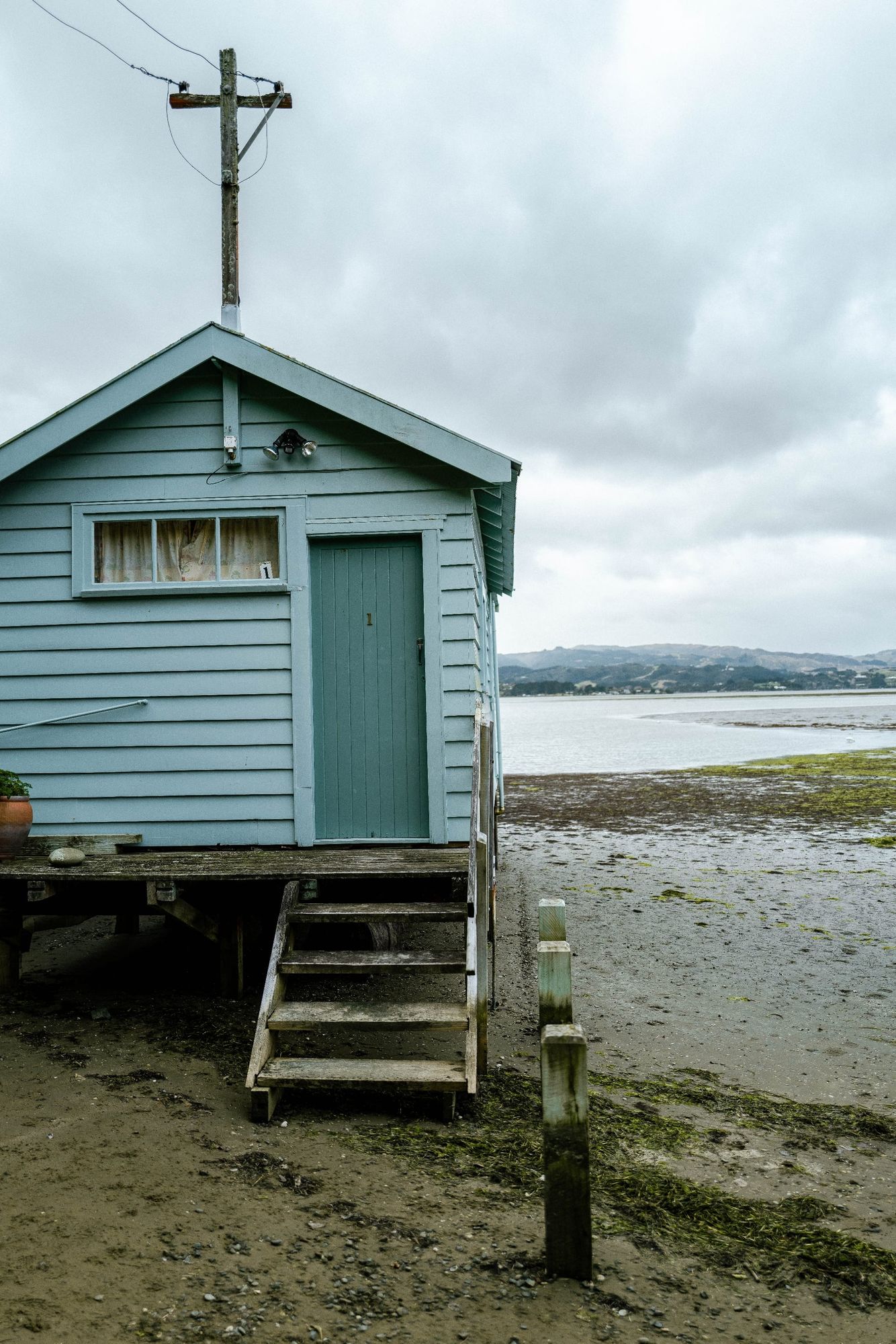 Blue cabin by coastal shore