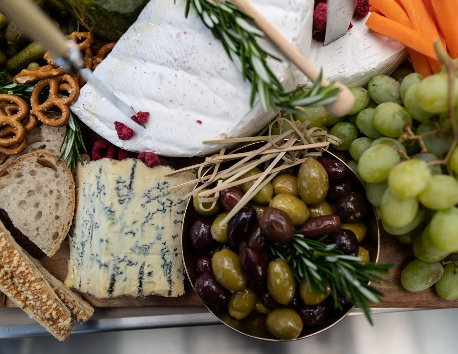 Board with cheese, olives, and fruit