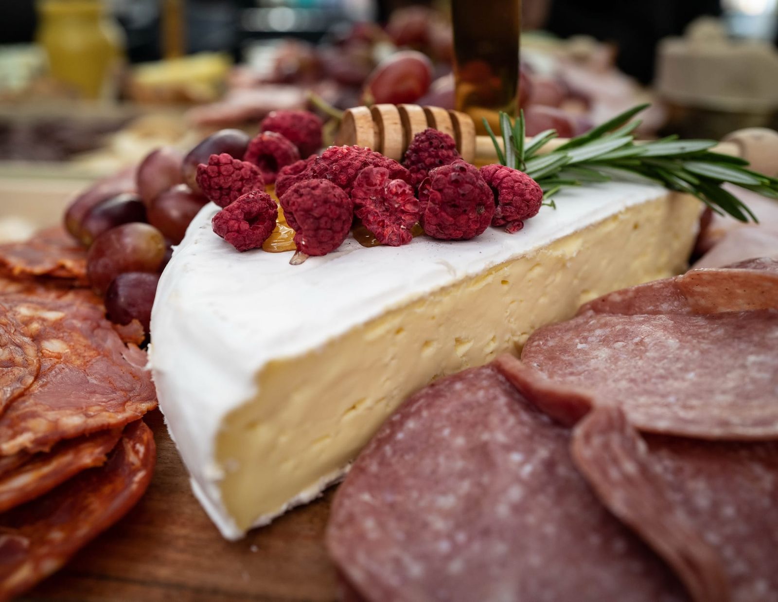Cheese and cured meats with honey and raspberries