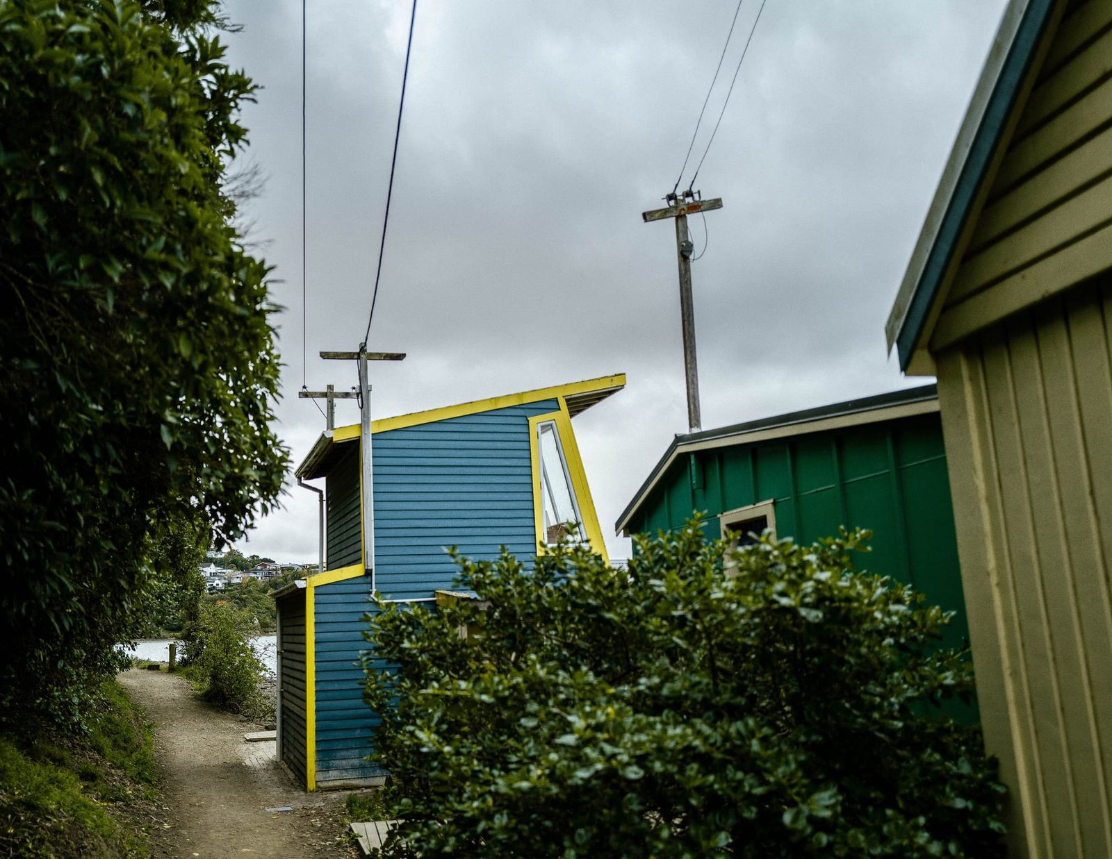 Colourful houses and pathway under stormy sky