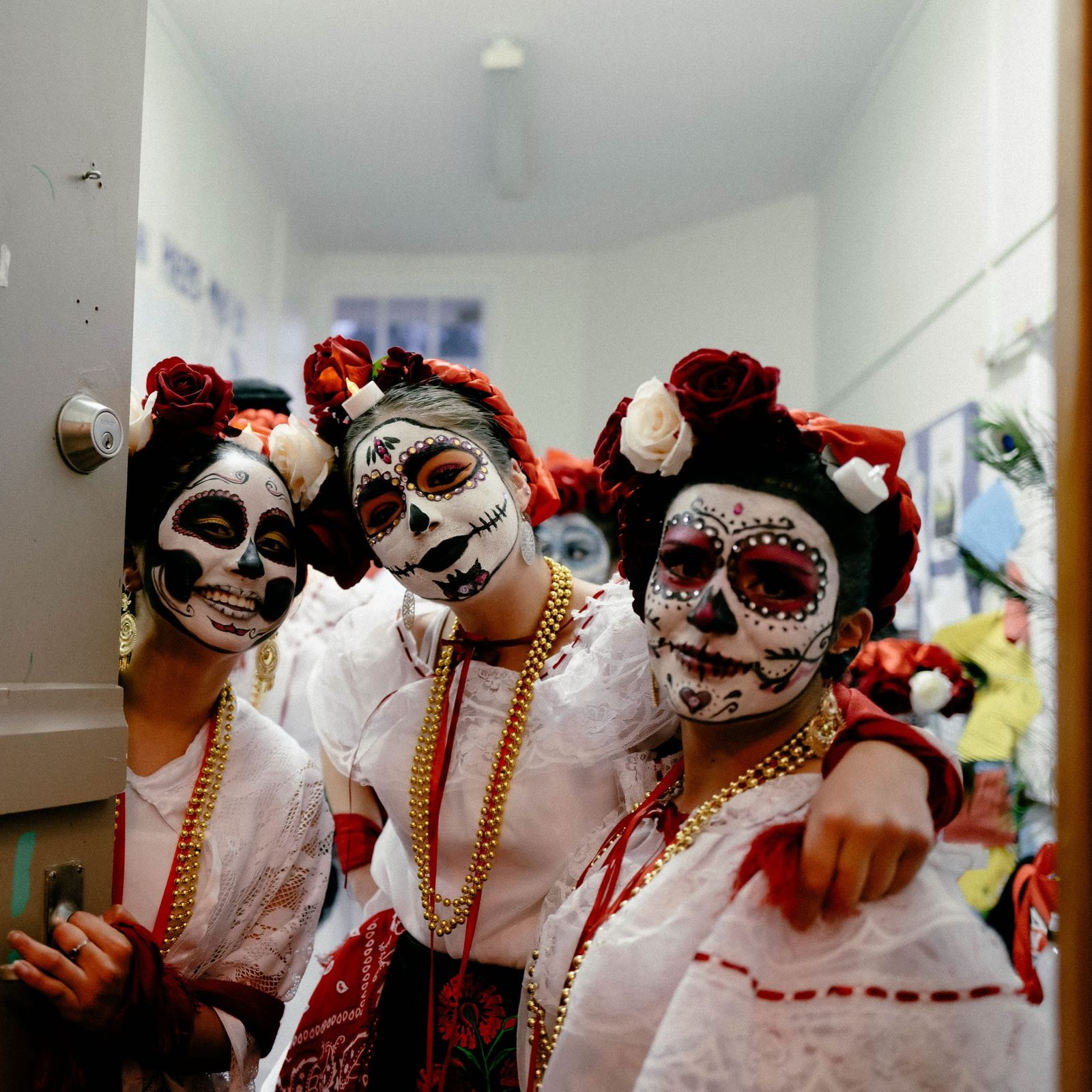 Three women in Day of the Dead costumes