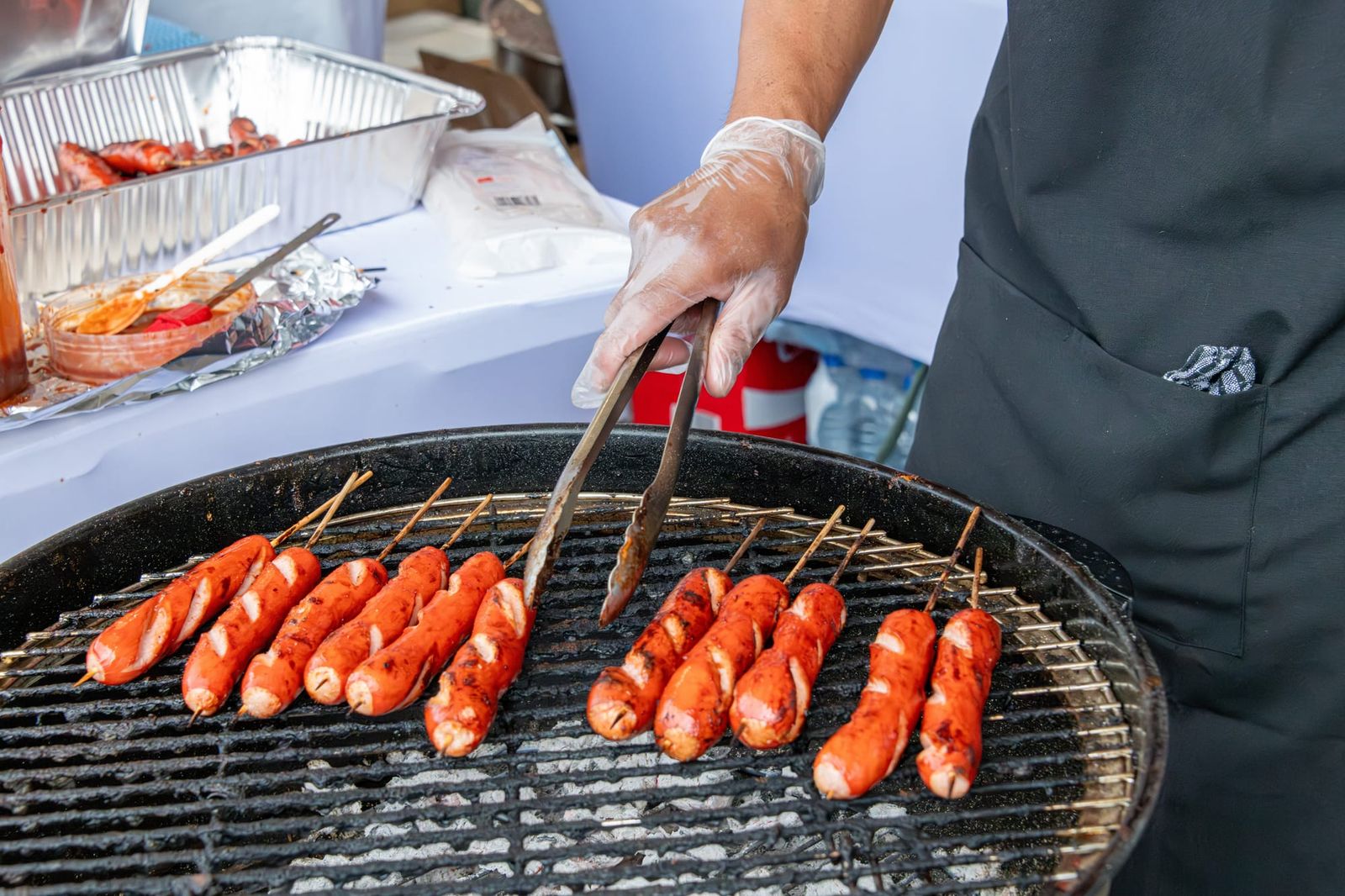 Turning sausages on a barbecue