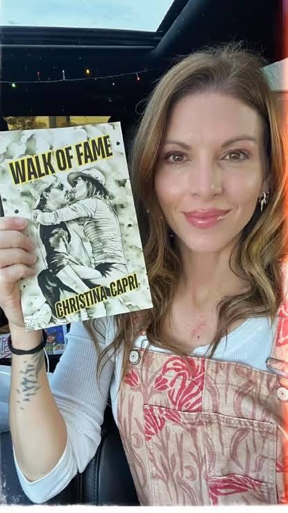 Author Walk of Fame&nbsp;by Christina Capri holding a copy of her book Walk of Fame