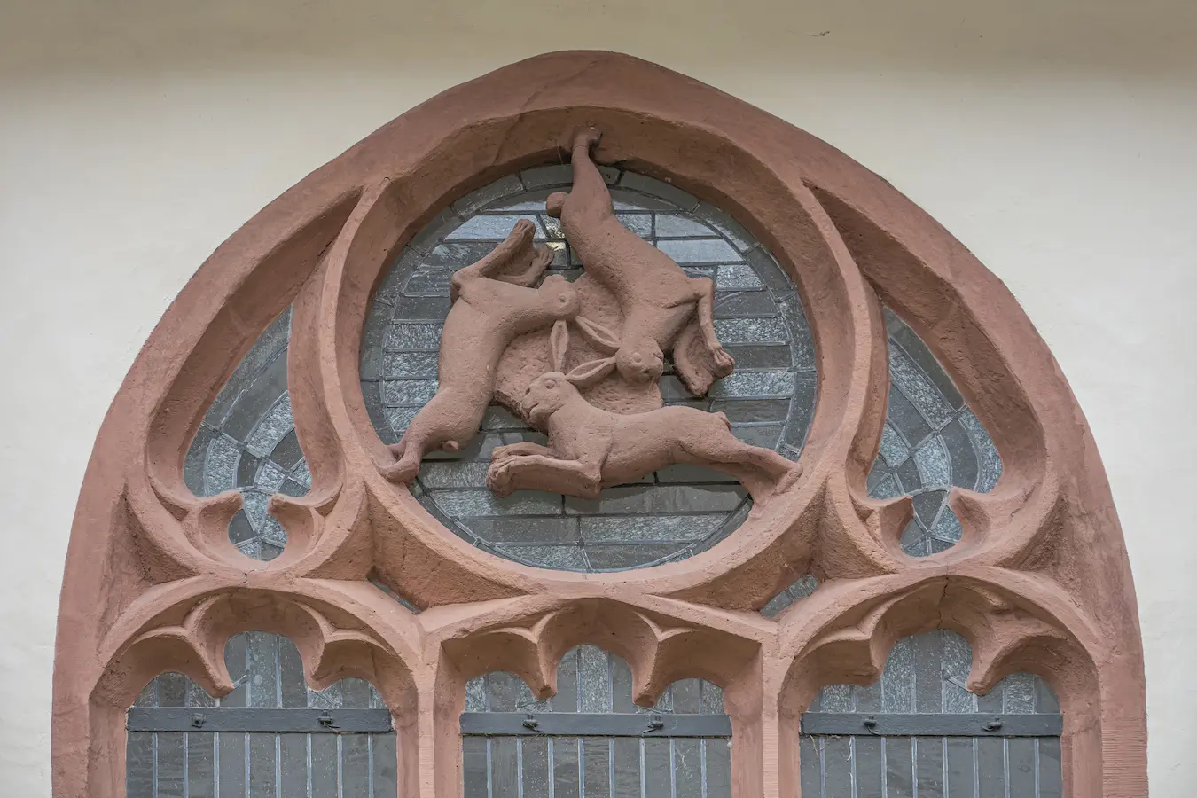 Three hares motif carved in church architecture forming circular shared-ear design