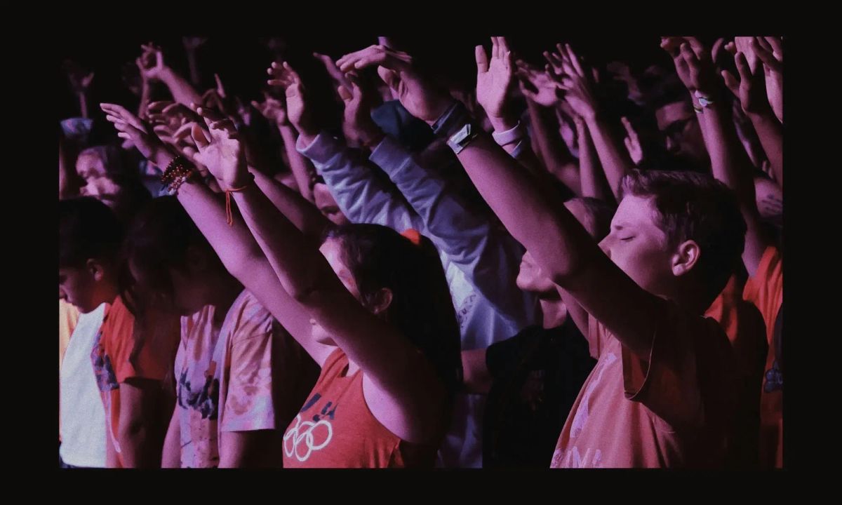 Congregation with raised hands during a modern evangelical worship service