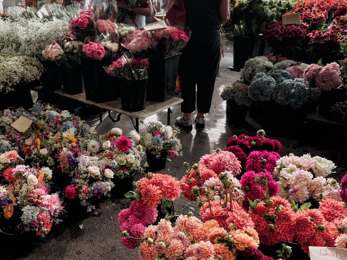 The Jonima Flowers stand at the farmers market. Dahlias, mixed blooms and hydrangea are on display.