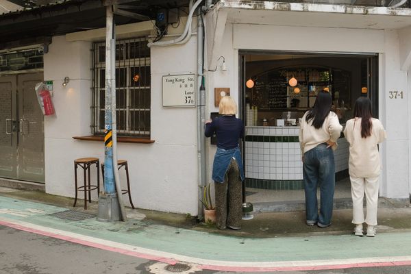 People gathered around a shopfront on the corner of Yong Kang Street, Taipei