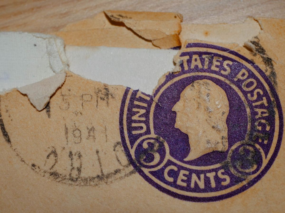 A torn letter with a stamp that says United States postage 3 cents