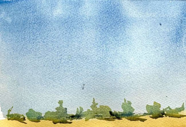 Hazy distant tree line over soft fields