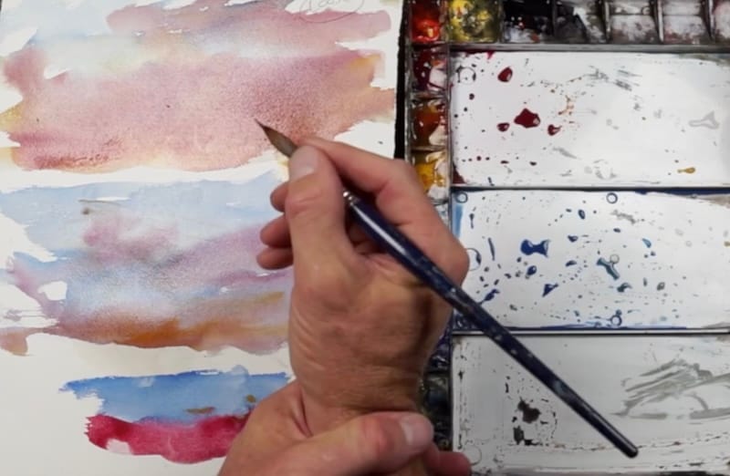 Demonstration of different ways to hold a watercolor brush for loose and controlled painting techniques