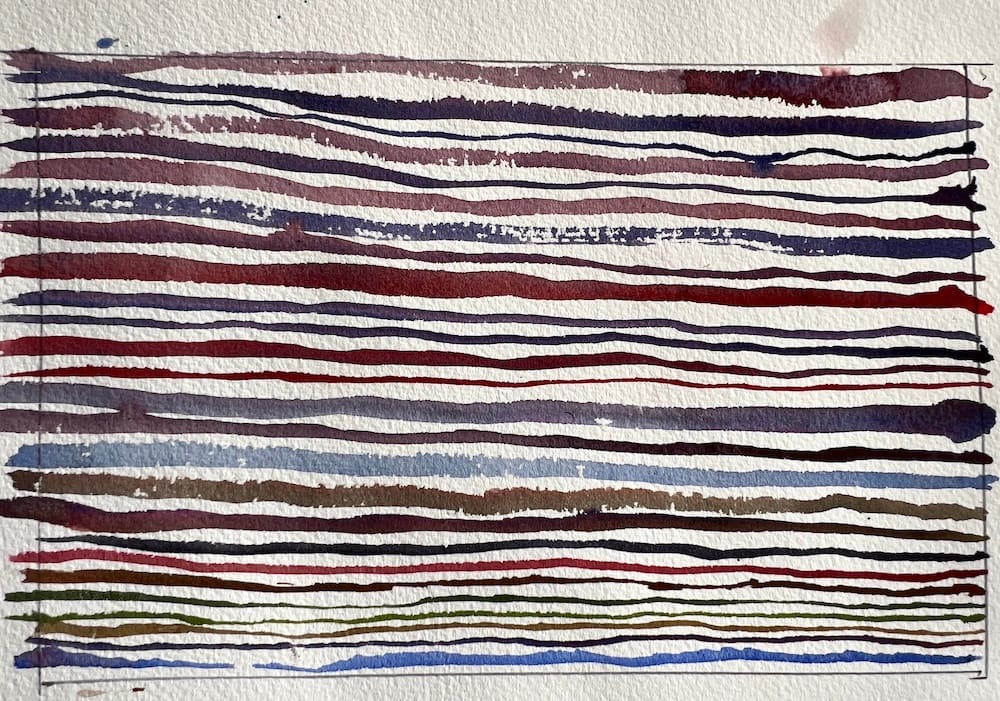 Watercolor paper filled with horizontal painted lines in different colors showing a brush control line challenge exercise